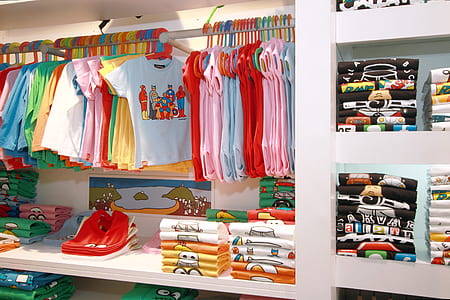 toddler's clothing display on white shelf thumbnail