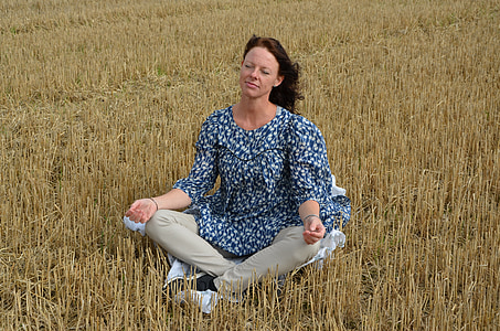 woman wearing blue top in grass field thumbnail