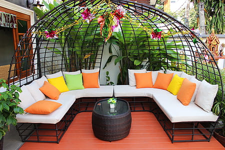 white sectional couch surrounded by plants thumbnail