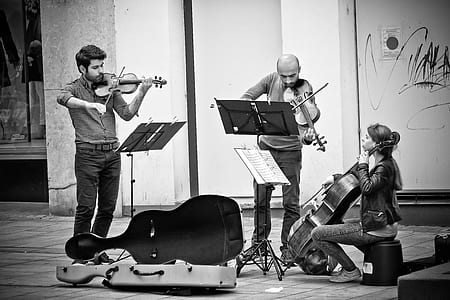 two men and one woman playing guitars and violin thumbnail