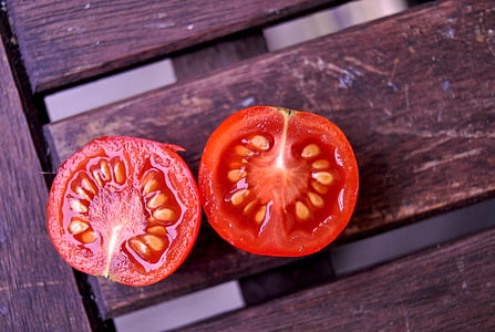 two slice tomato on brown wooden surface thumbnail