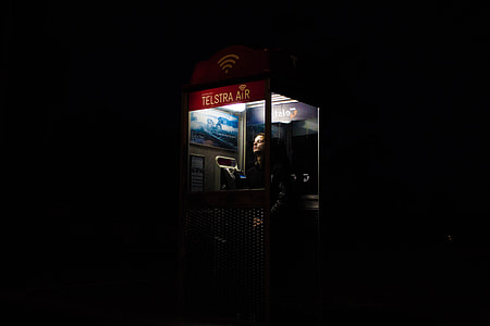 photo of man inside telephone booth thumbnail