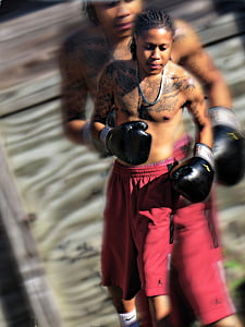 man in red Air Jordan jersey shorts and pair of black boxing gloves thumbnail