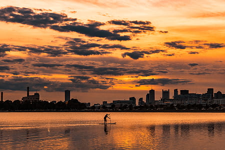 silhouette of man in black boat during sunset thumbnail
