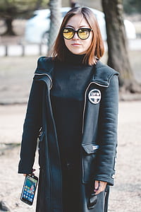 walking woman holding iPhone at the park thumbnail