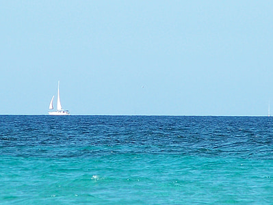 white sailboat under clear blue sky thumbnail