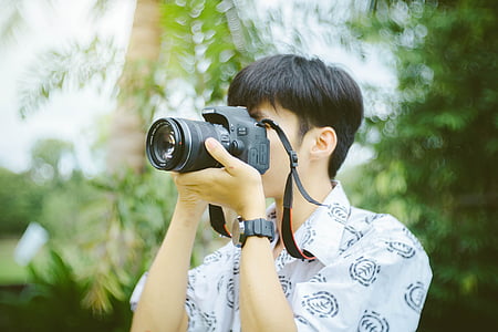man holding DSLR camera taking shot during daytime thumbnail
