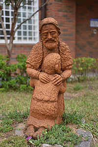man hugging child statuette thumbnail