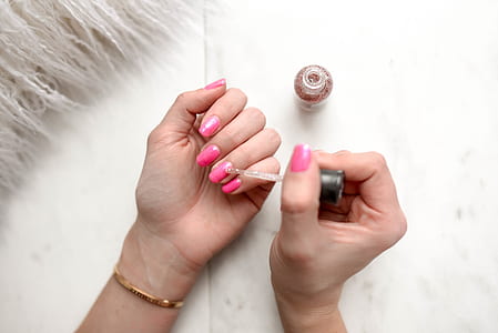 person holding nail polish thumbnail