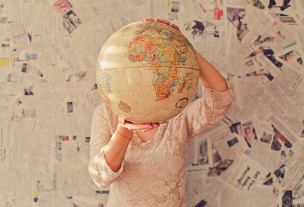person holding a globe thumbnail