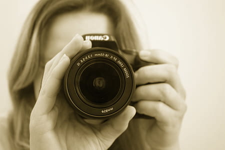 woman holding black Canon camera thumbnail
