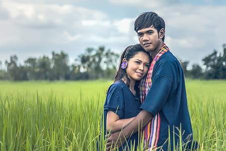 man and woman hugging on green grass field thumbnail