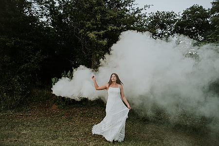 woman in white dress standing on green grass outdoors thumbnail