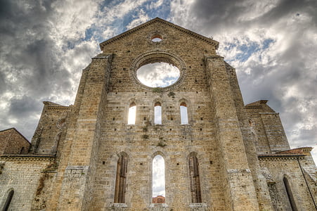 brown brick cathedral wall under cloudy skies thumbnail