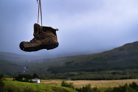 hanged brown hiking shoes over ground thumbnail