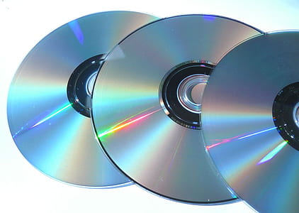 three compact discs on white surface thumbnail