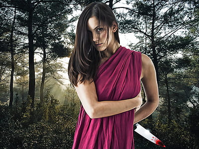 woman in purple shawl holding knife with blood stain thumbnail
