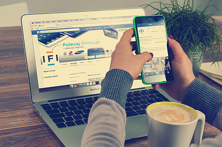 person on gray sweatshirt facing MacBook Pro thumbnail
