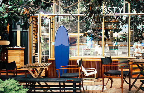 Blue Surfboard Leaning on Desk thumbnail