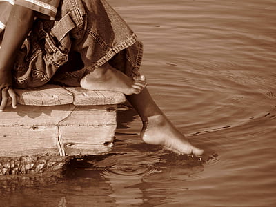 boy sitting on boat dock thumbnail
