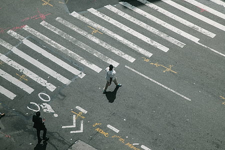 man in white shirt standing on gray roadway thumbnail