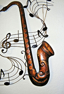 brass-colored saxophone on white surface thumbnail