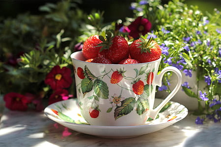 red strawberries on white ceramic teacup thumbnail