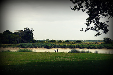 two person standing near body of water thumbnail