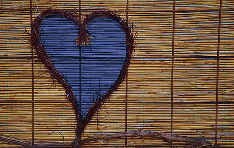 heart-shaped brown twig wreath on bamboo blind thumbnail