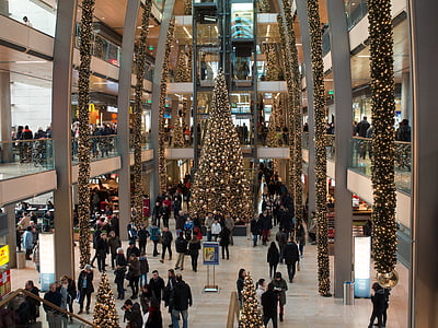 Christmas tree with string lights surrounded by people thumbnail