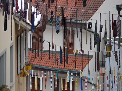 assorted-color necktie buntings near buildings at daytime thumbnail