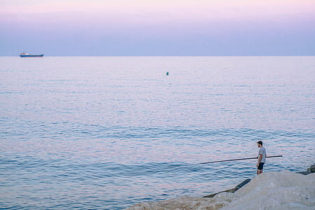man standing beside seashore thumbnail