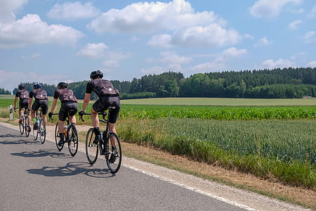 four man riding on bicycles thumbnail