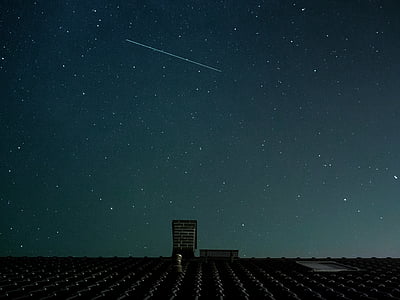 gray house under starry sky at nighttime thumbnail