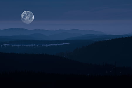 photography of mountain range under full moon thumbnail
