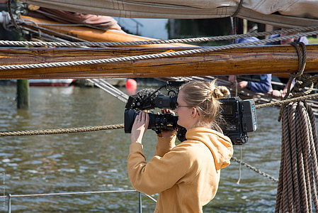 woman holding digital video camera thumbnail