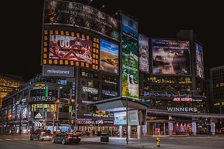 lighted building with billboards during night time thumbnail