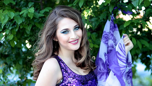 woman wearing purple sleeveless floral dress thumbnail