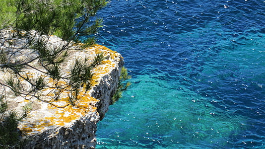 cliff above body of water thumbnail