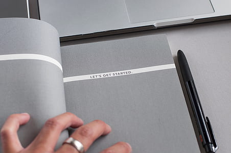 black pen beside book thumbnail
