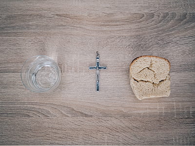 clear drinking glass beside black crucifix thumbnail