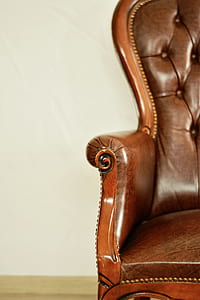 brown leather padded armchair with brown wooden base thumbnail