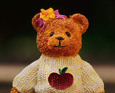 brown bear plush toy wearing white knitted sweater thumbnail