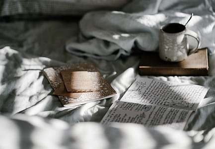 white mug near opened book thumbnail