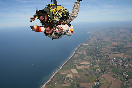 aerial photography of two men skydiving near blue sea at daytime thumbnail