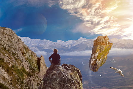 man sitting on rock formation near flying white bird near building on floating rock during daytime thumbnail