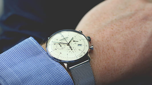 Person Wearing Silver-colored Analog Watch thumbnail