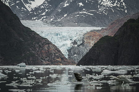 ice on body of water between mountain thumbnail