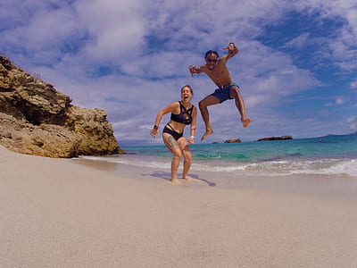 two person on beach during daytime thumbnail