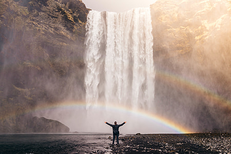 man in black long sleeve shirt in front of waterfalls thumbnail